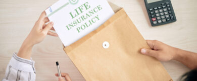 From above of man and woman with contract of life insurance policy sitting at table
